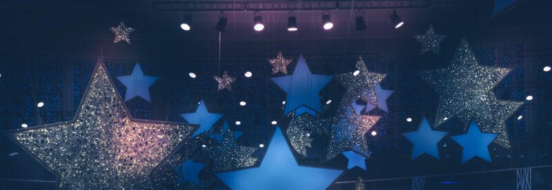 Vintage night shining stars shape spotlights soffits show stage performance background with gradient dark blue pink lilac purple lights